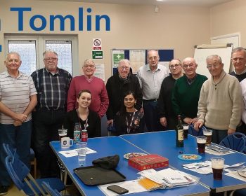 Don in a collective group photograph with two members from Tower Hamlets Health and all The Geezers members at the Tredegar Community Centre