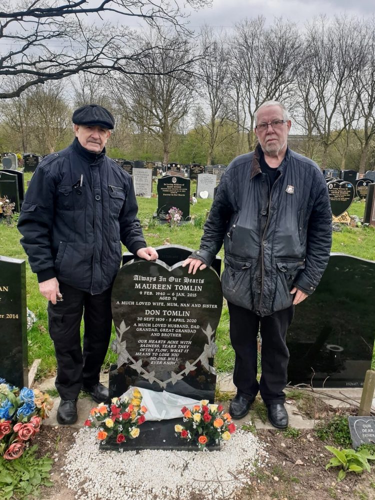 Geezers Ricky Ayliffe and Barrie Stradling at The City of London Cemetery & Crematorium, visiting the grave of their close friend and Geezers member Don Tomlin.