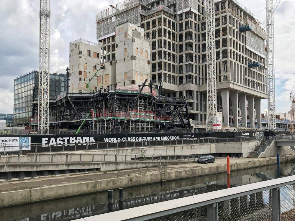 V&A East with black steel structure in front of London College of Fashion, Eastbank.