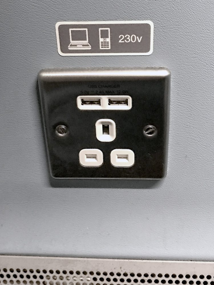 USB chargers and a normal power socket beside the seats on a Southern Train