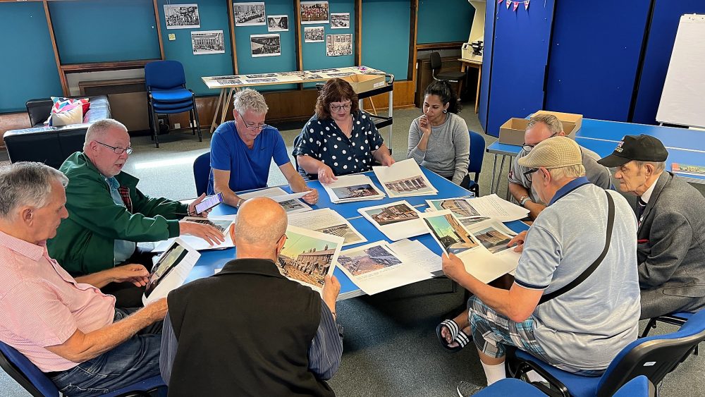 Geezers looking at David Granick's photos from the 1960s - 80s in the Tower Hamlets Archives