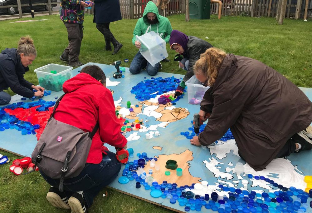 A great demonstration of how to make a bottle top mosaic - photo by Katja Rosenberg