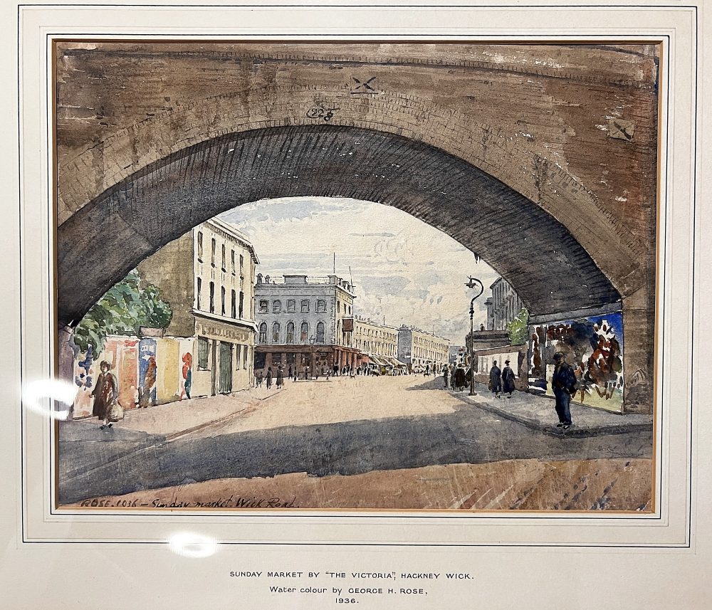 A 1936 watercolour by George Rose showing a Sunday Market by The Victoria pub, Hackney Wick.