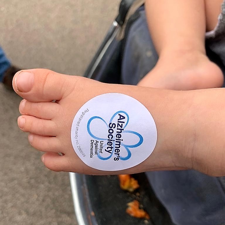 The Alzheimer's Society sticker on a baby