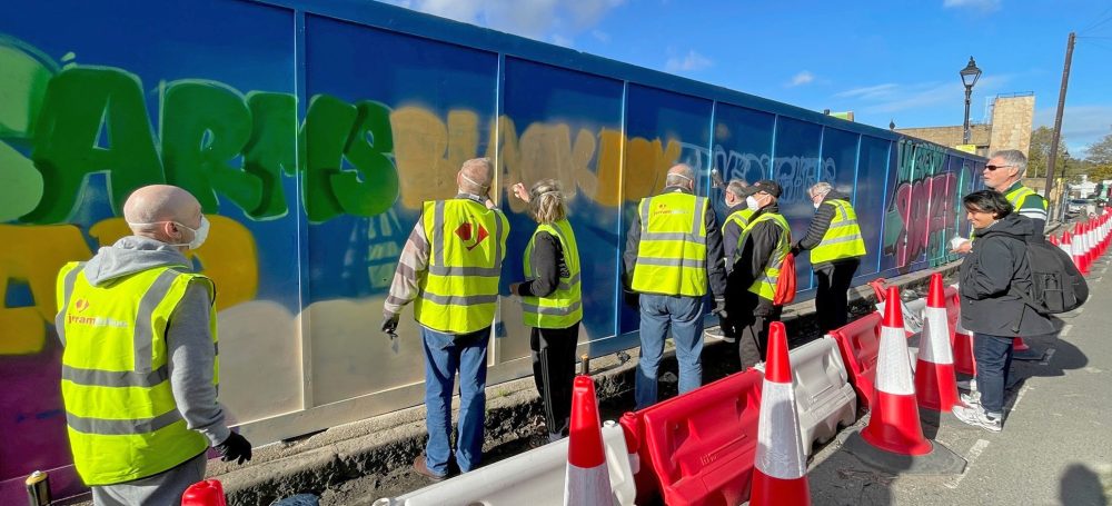 The Geezers painting lost pub names on the Jerram Falkus hoarding