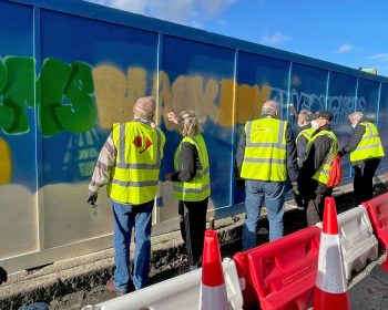 The Geezers painting lost pub names on the Jerram Falkus hoarding