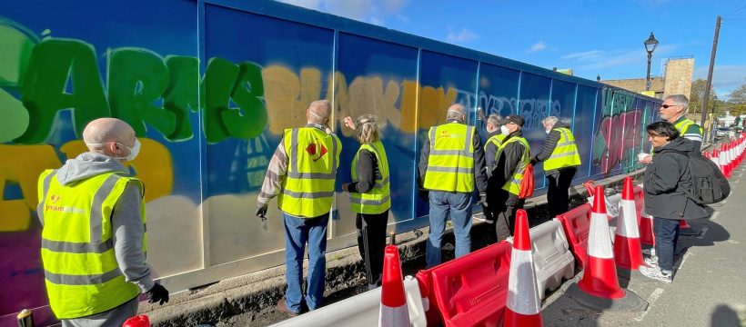 The Geezers painting lost pub names on the Jerram Falkus hoarding
