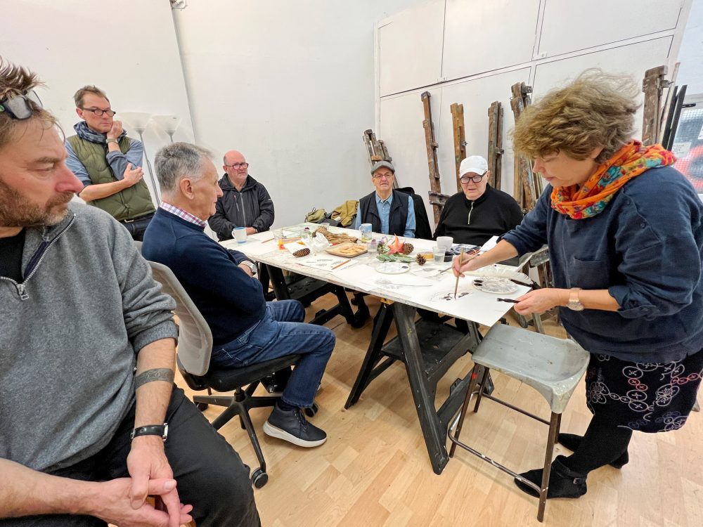 Joy Girvin demonstrating using indian ink at the Geezers 2nd art class at Chisenhale Studios