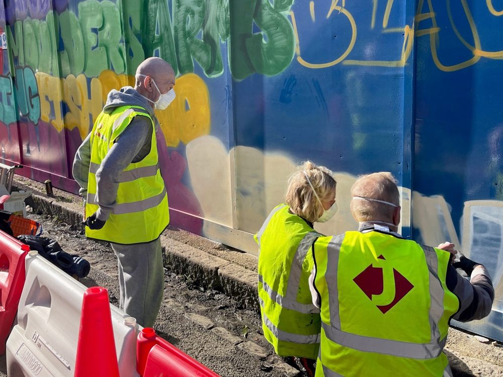 Steph, centre, giving guidance on using paint spray cans.