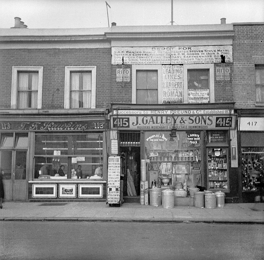 Photograph showing shop fronts of T.F Hawkins, Butcher, and J.Galley & Sons from outside, Nigel Henderson, 1949-54. ©Nigel Henderson Estate. Photo: Tate CC-BY-NC-ND 3.0 (Unported)