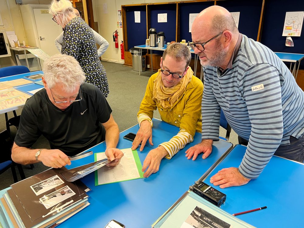 Some of the Geezers looking at old photos in the Tower Hamlets Archives