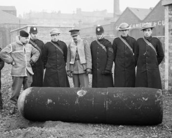 Photo courtesy of the Imperial War Museum (© IWM H 8281). It shows Police and Army bomb disposal officers with a defused German 1000kg 'Luftmine' (parachute mine) in Glasgow, 18 March 1941.