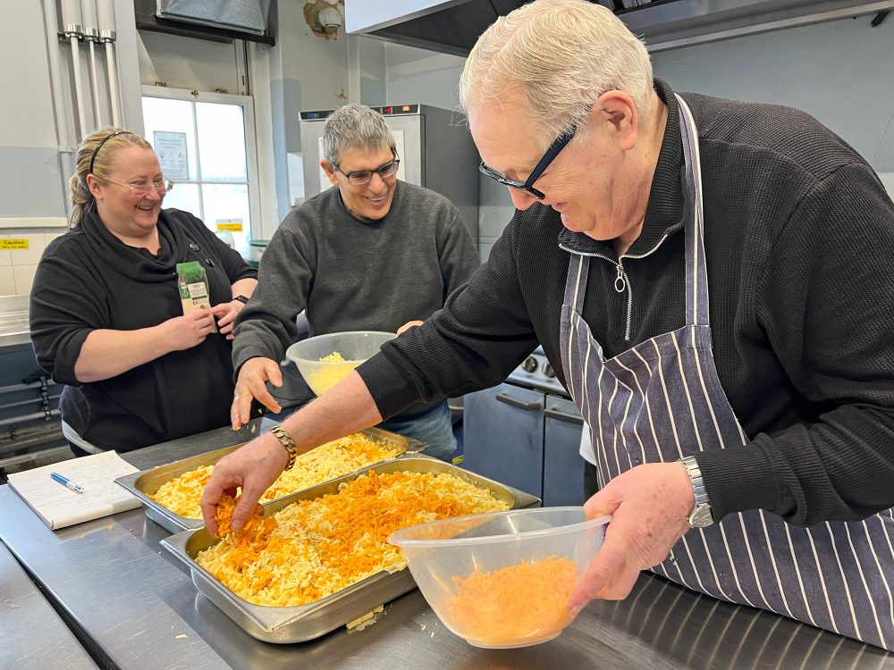 John Forster adding Red Leicester Cheese