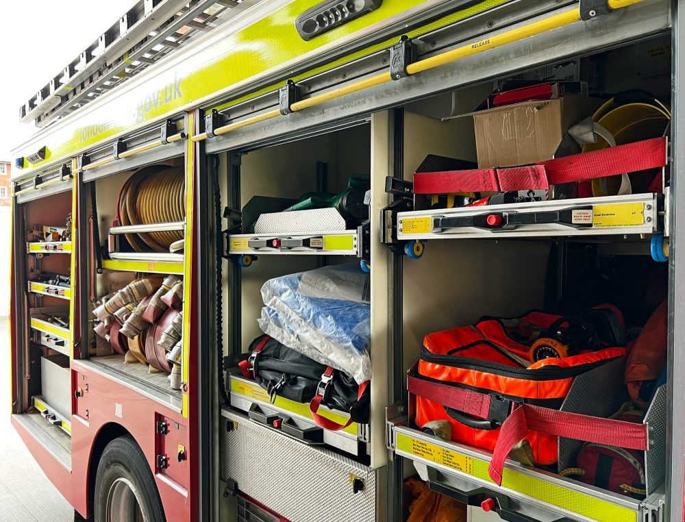 There's a mass of equipment all around the sides of a fire engine