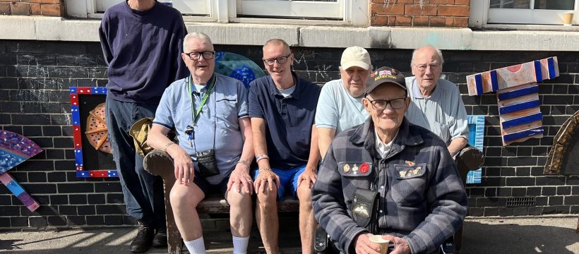Geezers pose with bench in sunshine