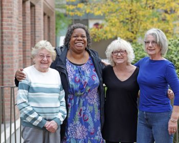 Group of 4 women outside with arms around eachother