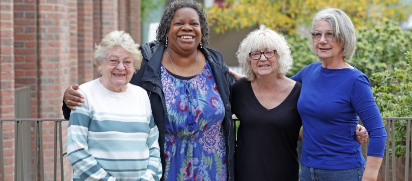 Group of 4 women outside with arms around eachother
